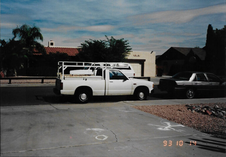 A white pick-up truck parked on a street, belonging to DPE Electric.