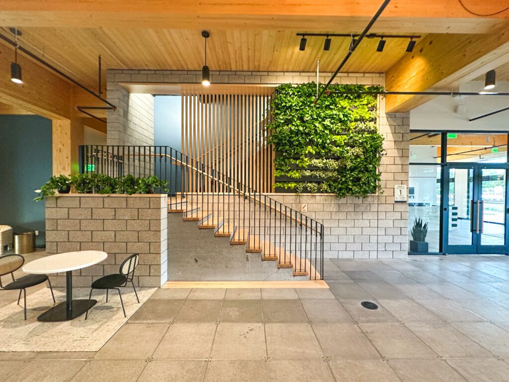 An office with a green wall and stairs.