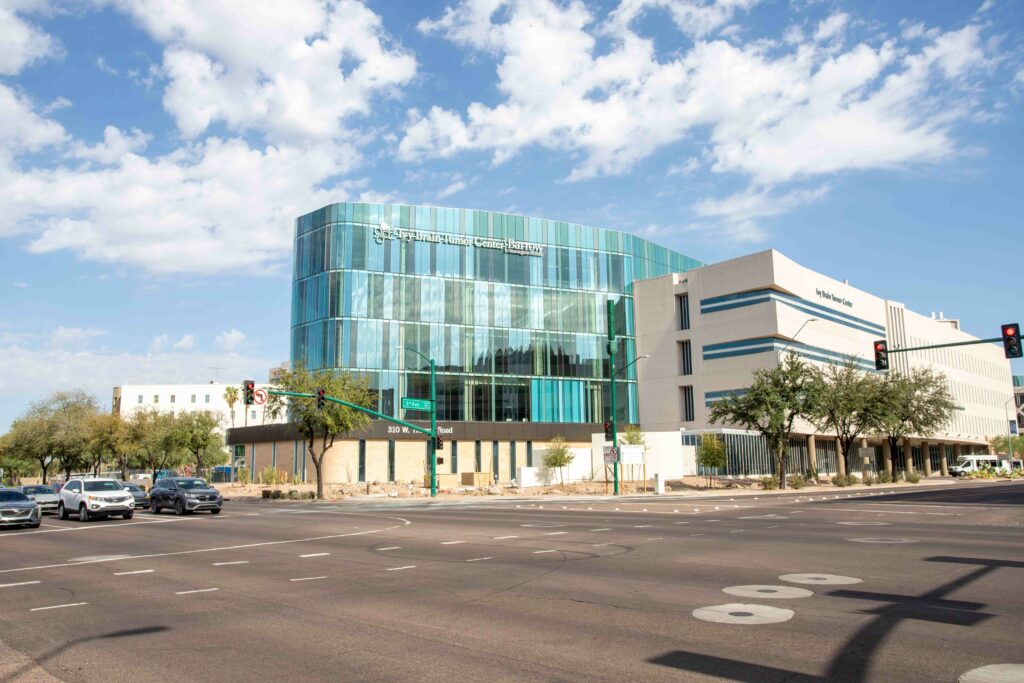 A building with a glass facade in front of Ivy Brain Tumor Center.