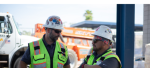 Mike Sulcer, a construction worker, discussing the construction career path with a colleague in front of a truck.